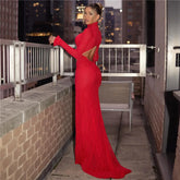 Woman in a red evening gown on a rooftop with cityscape background